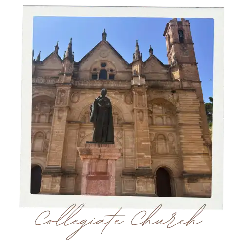 Front view of the Antequera Cathedral with the statue in front.