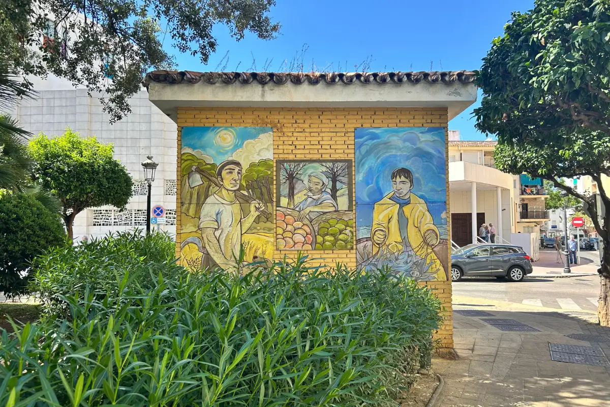 A mural of farmers on a small building in Estepona.