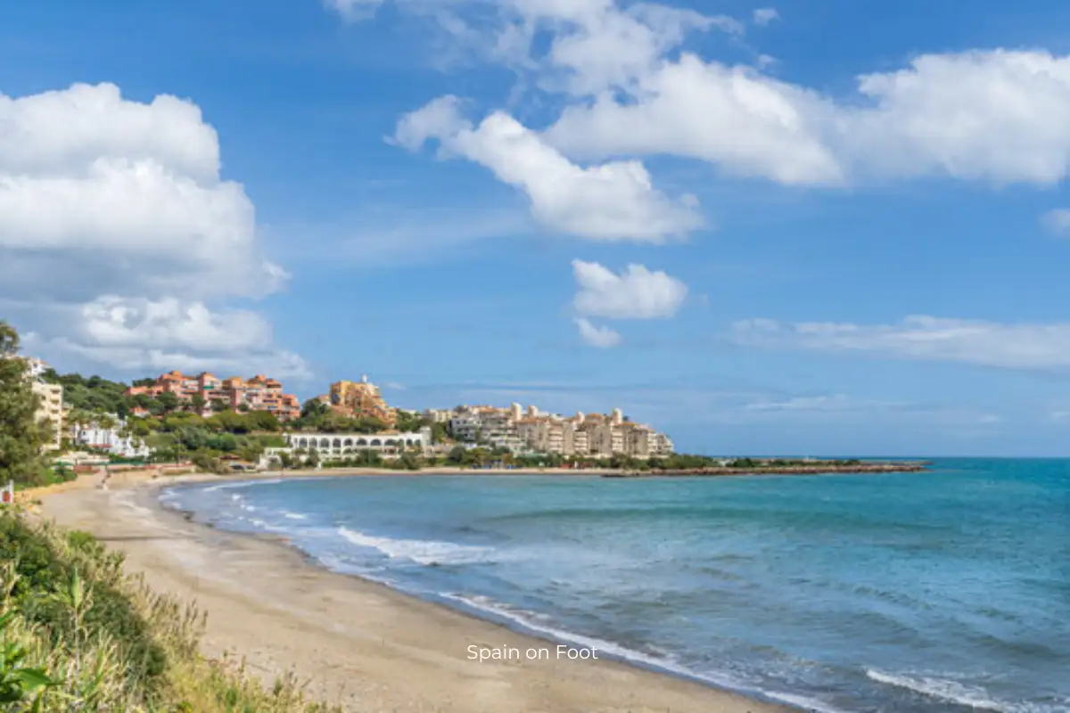 golden sands with the ocean and apartments in the background on playa del cristo.