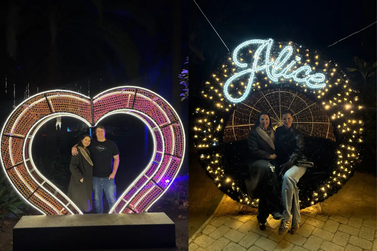 The authors are standing inside a big glowing heart, posing for a picture.