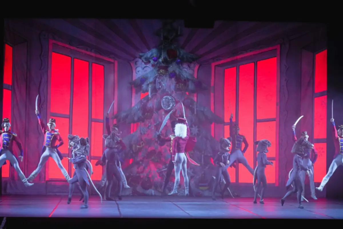 Men holding swords and dancing at the Nutcracker play in Malaga.