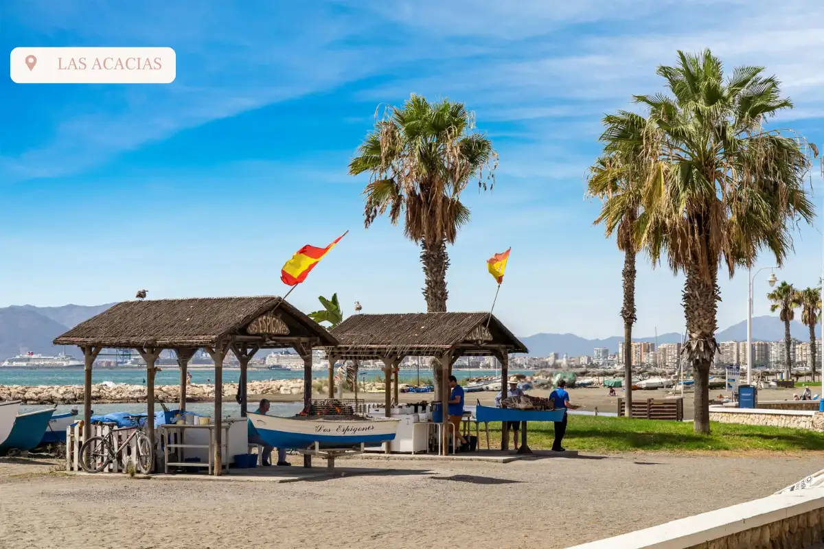 two huts on the promenade in Malaga with palm trees behind them at playa las Acacias.
